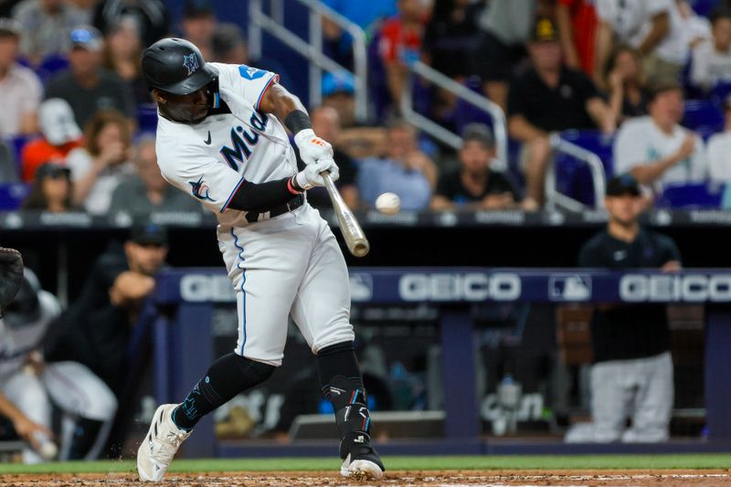 Jun 25, 2023; Miami, Florida, USA; Miami Marlins center fielder Jonathan Davis (49) hits a home run against the Pittsburgh Pirates during the third inning at loanDepot Park. Mandatory Credit: Sam Navarro-USA TODAY Sports