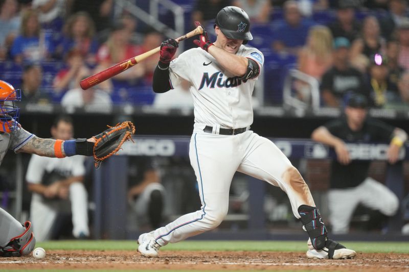 Sep 19, 2023; Miami, Florida, USA;  Miami Marlins catcher Nick Fortes (4) gets hit by a pitch in the ninth inning against the New York Mets at loanDepot Park. Mandatory Credit: Jim Rassol-USA TODAY Sports