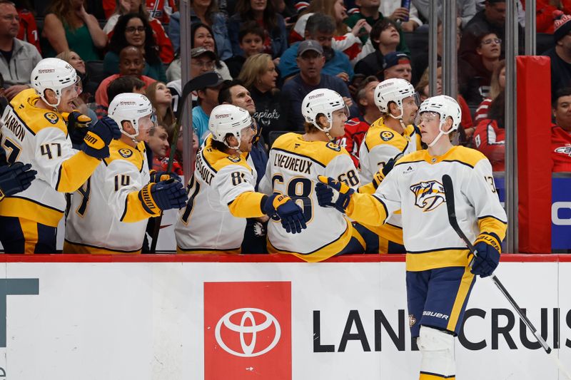 Nov 6, 2024; Washington, District of Columbia, USA; Nashville Predators center Juuso Parssinen (13) celebrates with teammates after scoring a goal against the Washington Capitals in the first period at Capital One Arena. Mandatory Credit: Geoff Burke-Imagn Images