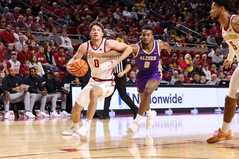 Dec 3, 2025; Ames, Iowa, USA; Iowa State Cyclones guard Nate Heise (0) drives past Alcorn State Braves guard Shane Lancaster (0) during the first half at James H. Hilton Coliseum. Mandatory Credit: Reese Strickland-Imagn Images