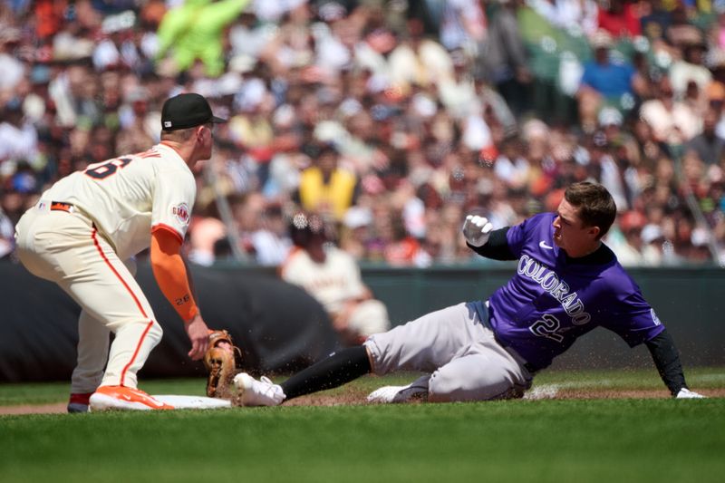 May 4, 2025; San Francisco, California, USA; Colorado Rockies outfielder Mickey Moniak (22) slides into third base with a triple against against San Francisco Giants third baseman Matt Chapman (26) during the fifth inning at Oracle Park. Mandatory Credit: Robert Edwards-Imagn Images