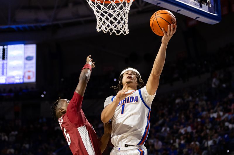 Jan 13, 2024; Gainesville, Florida, USA; Florida Gators guard Walter Clayton Jr. (1) shoots the ball over Arkansas Razorbacks guard Layden Blocker (6) during the second half at Exactech Arena at the Stephen C. O'Connell Center. Mandatory Credit: Matt Pendleton-USA TODAY Sports