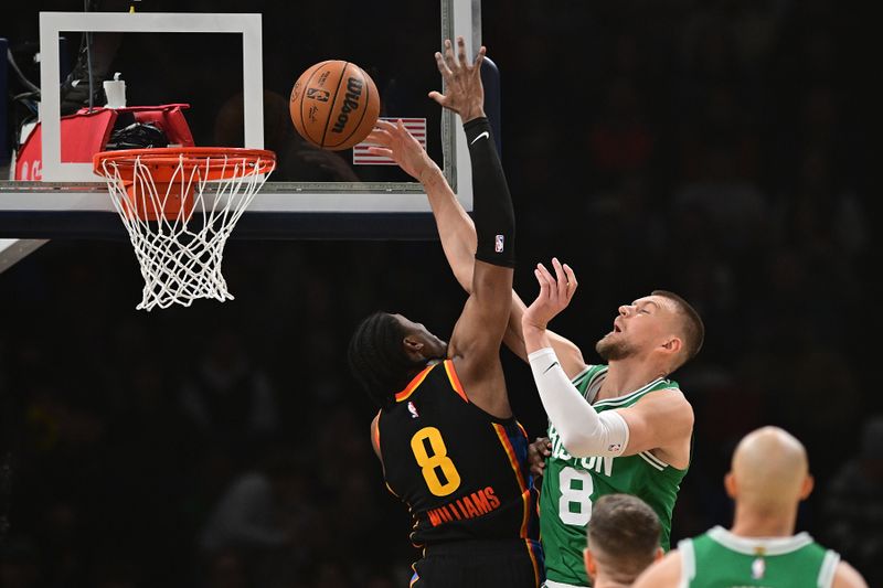 OKLAHOMA CITY, OKLAHOMA - JANUARY 5: Kristaps Porzingis #8 of the Boston Celtics attacks the rim in front of Jalen Williams #8 of the Oklahoma City Thunder during the first half at Paycom Center on January 5, 2025 in Oklahoma City, Oklahoma. NOTE TO USER: User expressly acknowledges and agrees that, by downloading and or using this photograph, User is consenting to the terms and conditions of the Getty Images License Agreement. (Photo by Joshua Gateley/Getty Images)