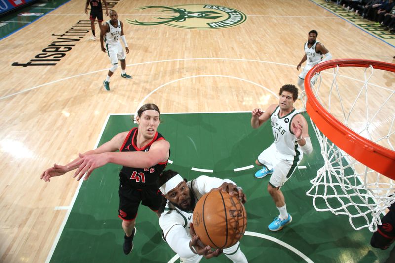MILWAUKEE, WI - APRIL 5: Jae Crowder #99 of the Milwaukee Bucks goes up for the rebound during the game against the Toronto Raptors on April 5, 2024 at the Fiserv Forum Center in Milwaukee, Wisconsin. NOTE TO USER: User expressly acknowledges and agrees that, by downloading and or using this Photograph, user is consenting to the terms and conditions of the Getty Images License Agreement. Mandatory Copyright Notice: Copyright 2024 NBAE (Photo by Gary Dineen/NBAE via Getty Images).