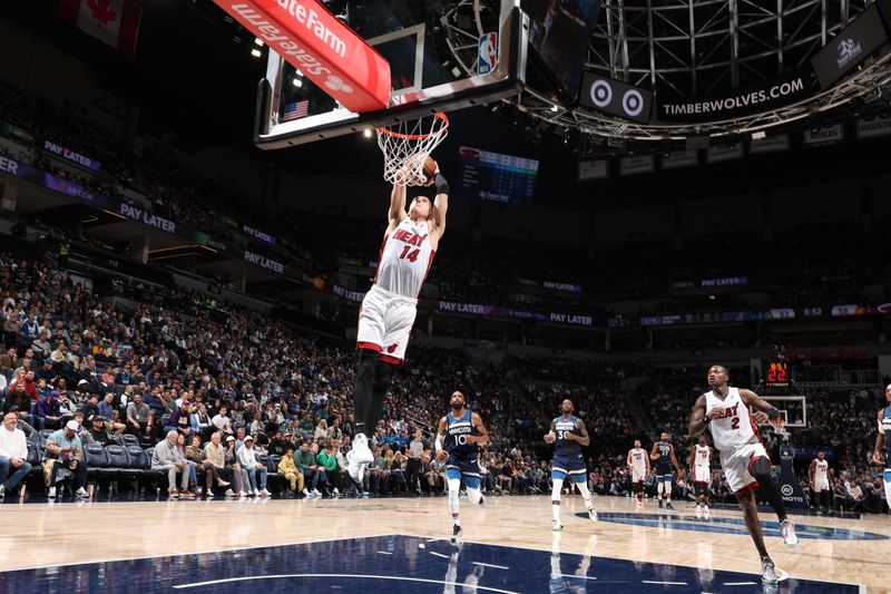 MINNEAPOLIS, MN -  NOVEMBER 10: Tyler Herro #14 of the Miami Heat dunks the ball during the game against the Minnesota Timberwolves on November 10, 2024 at Target Center in Minneapolis, Minnesota. NOTE TO USER: User expressly acknowledges and agrees that, by downloading and or using this Photograph, user is consenting to the terms and conditions of the Getty Images License Agreement. Mandatory Copyright Notice: Copyright 2024 NBAE (Photo by David Sherman/NBAE via Getty Images)