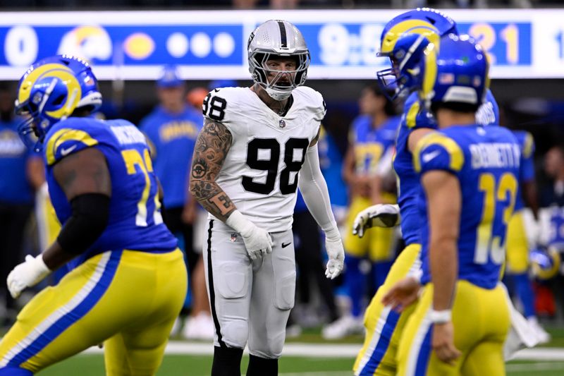 Las Vegas Raiders defensive end Maxx Crosby, center, lines up against the Los Angeles Rams during the first half of a preseason NFL football game Saturday, Aug. 19, 2023, in Inglewood, Calif. (AP Photo/Alex Gallardo)