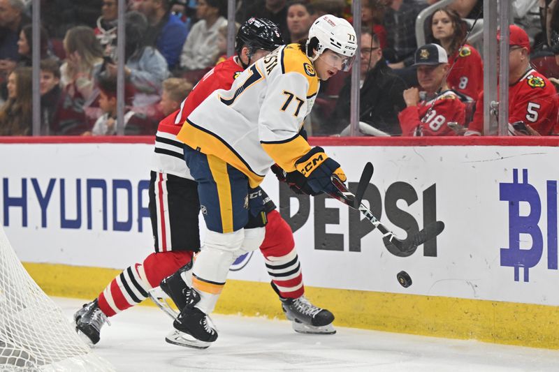 Apr 12, 2024; Chicago, Illinois, USA; Nashville Predators forward Luke Evangelista (77) chases after a loose puck in the first period against the Chicago Blackhawks at United Center. Mandatory Credit: Jamie Sabau-USA TODAY Sports