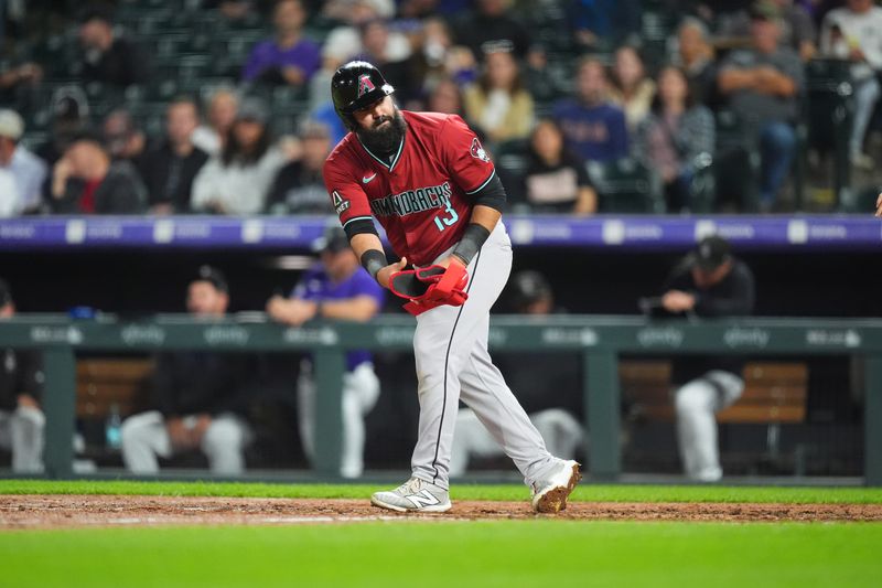 Sep 17, 2024; Denver, Colorado, USA; Arizona Diamondbacks second base Luis Guillorme (13) takes a bases on balls in the fourth inning against the Colorado Rockies at Coors Field. Mandatory Credit: Ron Chenoy-Imagn Images