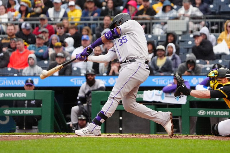 May 4, 2024; Pittsburgh, Pennsylvania, USA; Colorado Rockies catcher Elias Diaz (35) hits a double against the Pittsburgh Pirates during the fifth inning at PNC Park. Mandatory Credit: Gregory Fisher-USA TODAY Sports