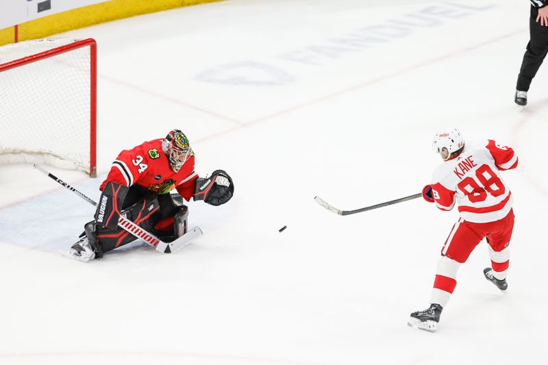 Feb 25, 2024; Chicago, Illinois, USA; Detroit Red Wings right wing Patrick Kane (88) shoots and scores game winning goal against Chicago Blackhawks goaltender Petr Mrazek (34) in overtime at United Center. Mandatory Credit: Kamil Krzaczynski-USA TODAY Sports