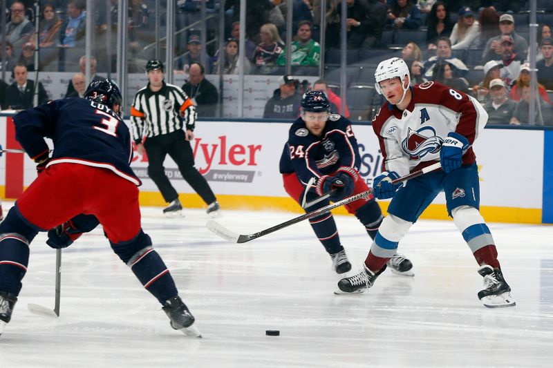 Oct 16, 2025; Columbus, Ohio, USA; Colorado Avalanche defenseman Cale Makar (8) passes the puck as Columbus Blue Jackets center Charlie Coyle (3) defends during the first period at Nationwide Arena. Mandatory Credit: Russell LaBounty-Imagn Images