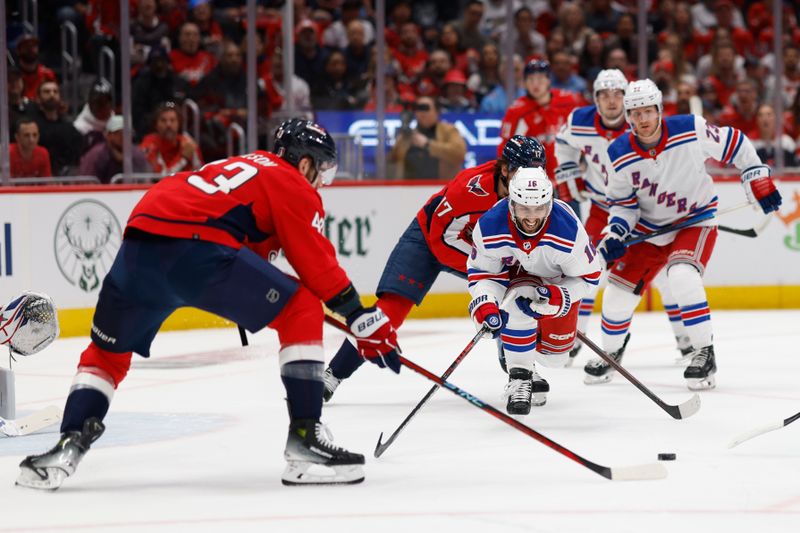 Apr 28, 2024; Washington, District of Columbia, USA; Washington Capitals right wing Tom Wilson (43) and New York Rangers center Vincent Trocheck (16) tech for the puck in the first period in game four of the first round of the 2024 Stanley Cup Playoffs at Capital One Arena. Mandatory Credit: Geoff Burke-USA TODAY Sports