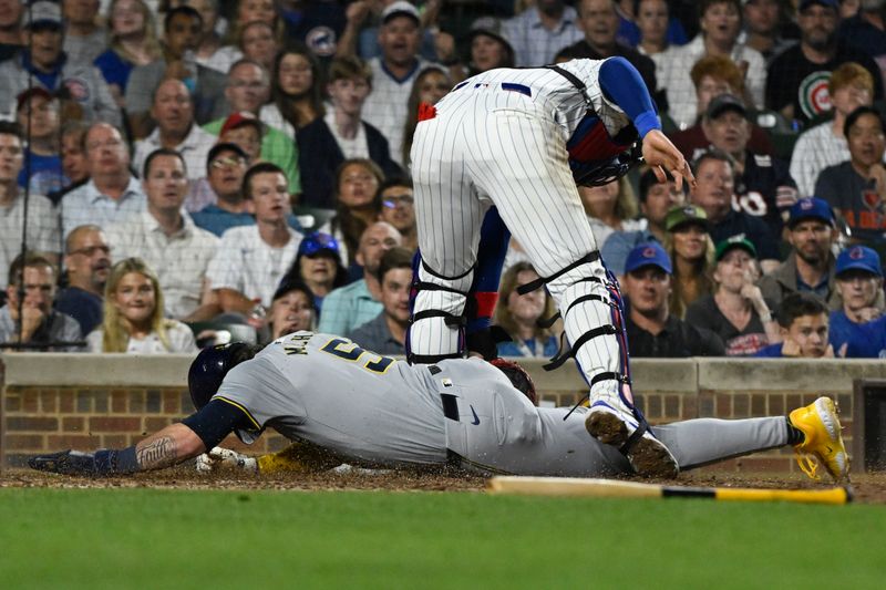 Jul 23, 2024; Chicago, Illinois, USA;   Milwaukee Brewers outfielder Garrett Mitchell (5) is tagged out at home by  Chicago Cubs catcher Miguel Amaya (9) during the sixth inning at Wrigley Field. Mandatory Credit: Matt Marton-USA TODAY Sports