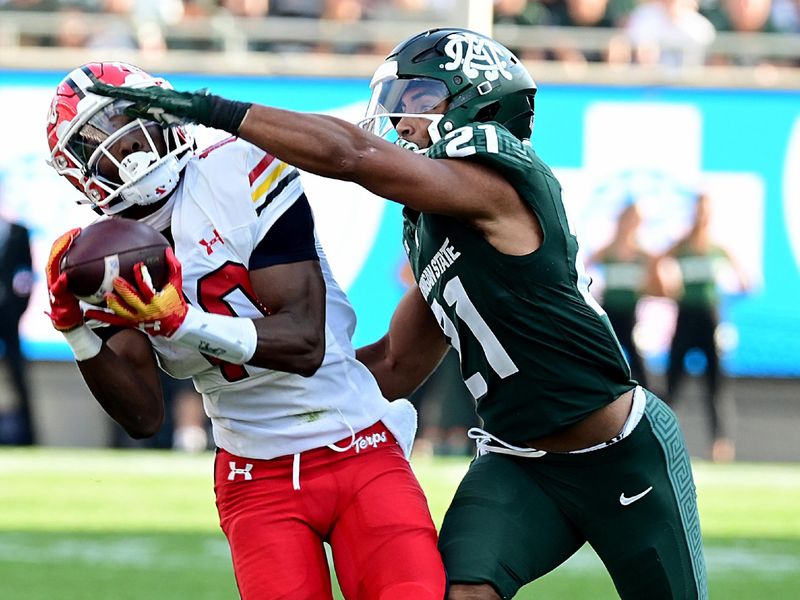 Sep 23, 2023; East Lansing, Michigan, USA;  Maryland Terrapins wide receiver Tai Felton (10) pulls in a pass in spite of Michigan State Spartans defensive back Dillon Tatum (21) in the third quarter at Spartan Stadium. Mandatory Credit: Dale Young-USA TODAY Sports