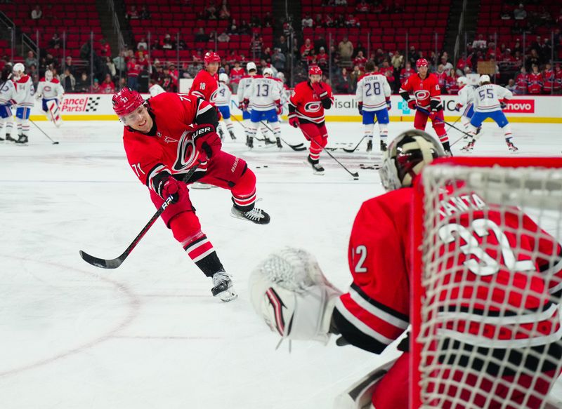 Dec 28, 2023; Raleigh, North Carolina, USA; Carolina Hurricanes right wing Jesper Fast (71) takes a shot during the warmups before the game Montreal Canadiens at PNC Arena. Mandatory Credit: James Guillory-USA TODAY Sports