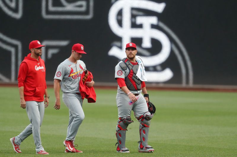 Jul 22, 2024; Pittsburgh, Pennsylvania, USA; St. Louis Cardinals pitching coach Dusty Blake (left) and starting pitcher Andre Pallante (middle) and catcher Pedro Pagés (43) make their way in from the bullpen to play the Pittsburgh Pirates at PNC Park. Mandatory Credit: Charles LeClaire-USA TODAY Sports