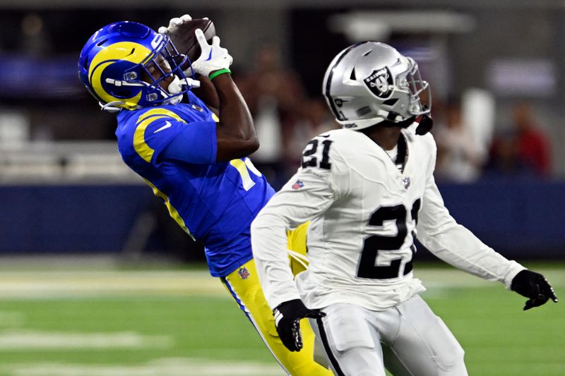 Los Angeles Rams wide receiver Xavier Smith, left, makes a catch behind Las Vegas Raiders cornerback Amik Robertson (21) during the second half of a preseason NFL football game Saturday, Aug. 19, 2023, in Inglewood, Calif. (AP Photo/Alex Gallardo)