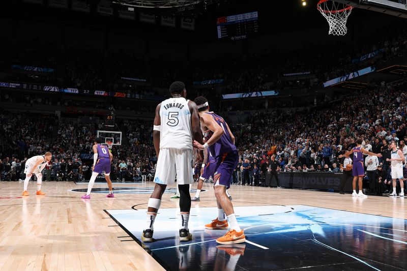 MINNEAPOLIS, MN - NOVEMBER 17: Anthony Edwards #5 of the Minnesota Timberwolves and Devin Booker #1 of the Phoenix Suns look on during the game on November 17, 2024 at Target Center in Minneapolis, Minnesota. NOTE TO USER: User expressly acknowledges and agrees that, by downloading and or using this Photograph, user is consenting to the terms and conditions of the Getty Images License Agreement. Mandatory Copyright Notice: Copyright 2024 NBAE(Photo by David Sherman/NBAE via Getty Images)