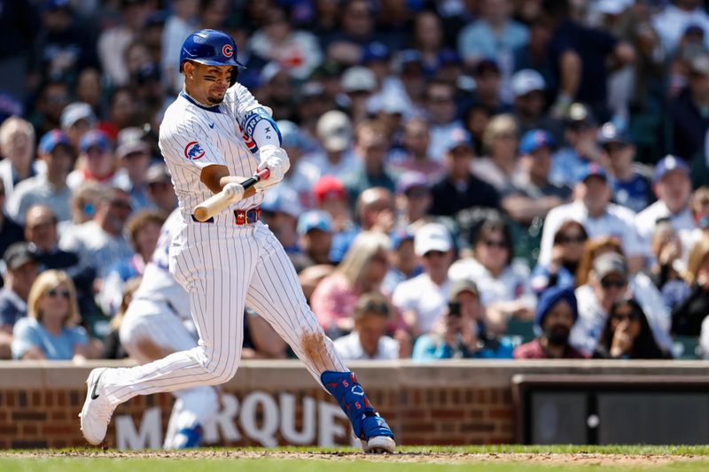 May 3, 2024; Chicago, Illinois, USA; Chicago Cubs third baseman Christopher Morel (5) hits a solo home run against the Milwaukee Brewers during the sixth inning at Wrigley Field. Mandatory Credit: Kamil Krzaczynski-USA TODAY Sports