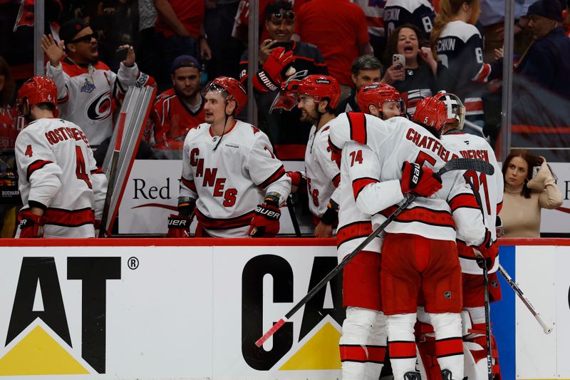 May 6, 2025; Washington, District of Columbia, USA; Carolina Hurricanes defenseman Jaccob Slavin (74) celebrates with Hurricanes defenseman Jalen Chatfield (5) while leaving the ice after their game against the Washington Capitals in game one of the second round of the 2025 Stanley Cup Playoffs at Capital One Arena. Mandatory Credit: Geoff Burke-Imagn Images