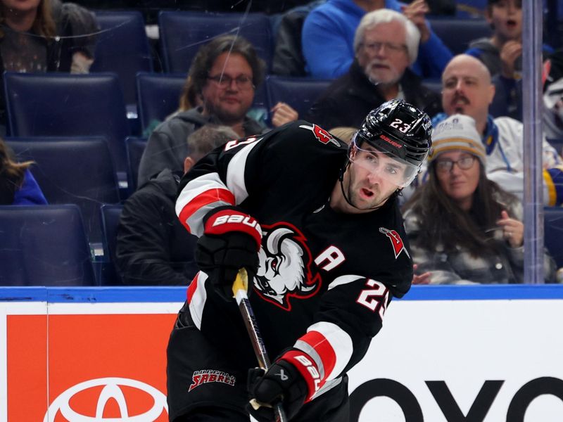 Nov 28, 2025; Buffalo, New York, USA;  Buffalo Sabres defenseman Mattias Samuelsson (23) takes a shot on goal during the second period against the New Jersey Devils at KeyBank Center. Mandatory Credit: Timothy T. Ludwig-Imagn Images