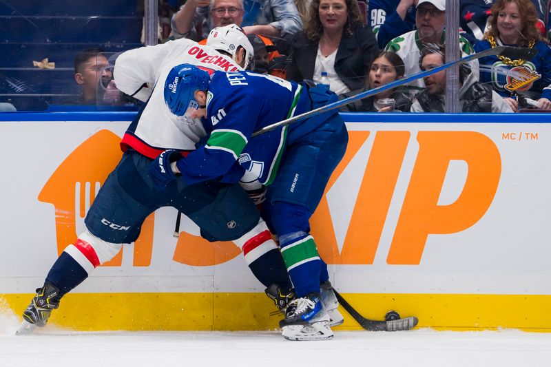 Mar 16, 2024; Vancouver, British Columbia, CAN; Vancouver Canucks forward Elias Pettersson (40) cehcks Washington Capitals forward Alex Ovechkin (8) in the third period at Rogers Arena. Washington won 2 -1. Mandatory Credit: Bob Frid-USA TODAY Sports