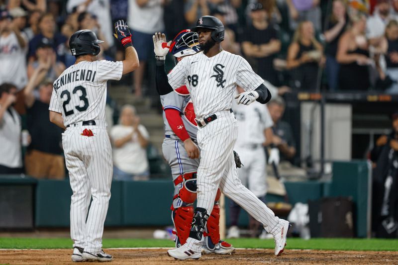 Jul 4, 2023; Chicago, Illinois, USA; Chicago White Sox center fielder Luis Robert Jr. (88) celebrates with left fielder Andrew Benintendi (23) after hitting a three-run home run against the Toronto Blue Jays during the sixth inning at Guaranteed Rate Field. Mandatory Credit: Kamil Krzaczynski-USA TODAY Sports