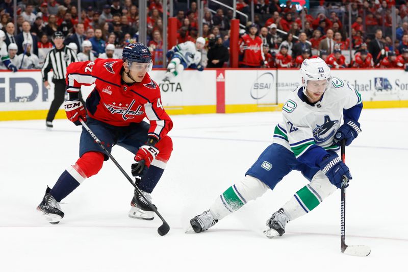 Feb 11, 2024; Washington, District of Columbia, USA; /v23/ skates with the puck as Washington Capitals defenseman Martin Fehervary (42) defends in overtime at Capital One Arena. Mandatory Credit: Geoff Burke-USA TODAY Sports