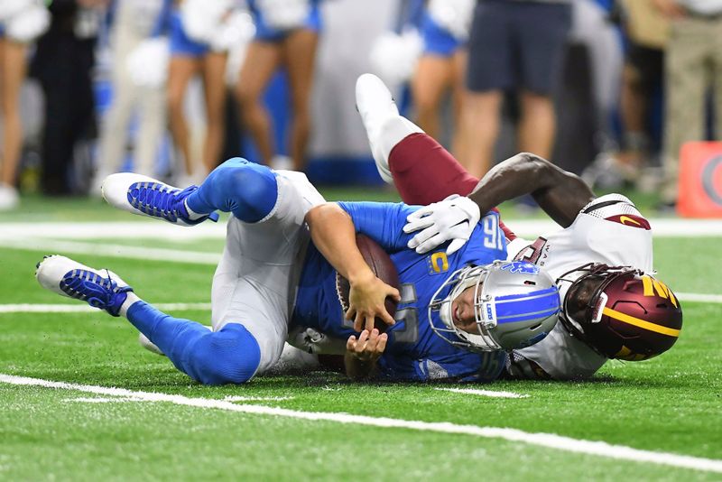 Detroit Lions quarterback Jared Goff (16) is sacked by Washington Commanders linebacker Jamin Davis (52) during the first half of an NFL football game Sunday, Sept. 18, 2022, in Detroit. (AP Photo/Lon Horwedel)