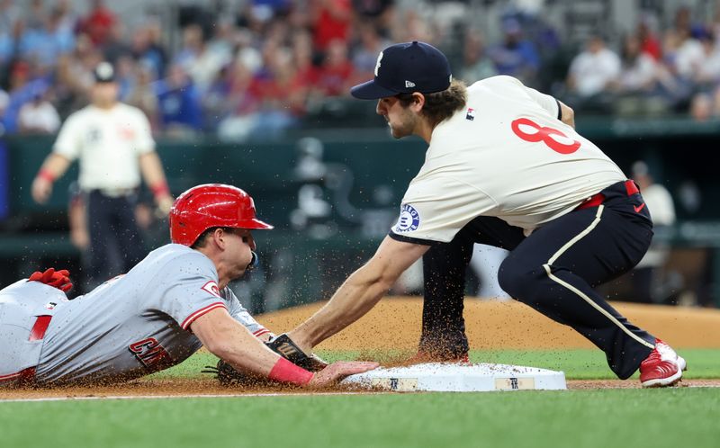 Apr 26, 2024; Arlington, Texas, USA;  Cincinnati Reds left fielder Spencer Steer (7) slides safely into third base ahead of teh tag by Texas Rangers third baseman Josh Smith (8) during the first inning at Globe Life Field. Mandatory Credit: Kevin Jairaj-USA TODAY Sports