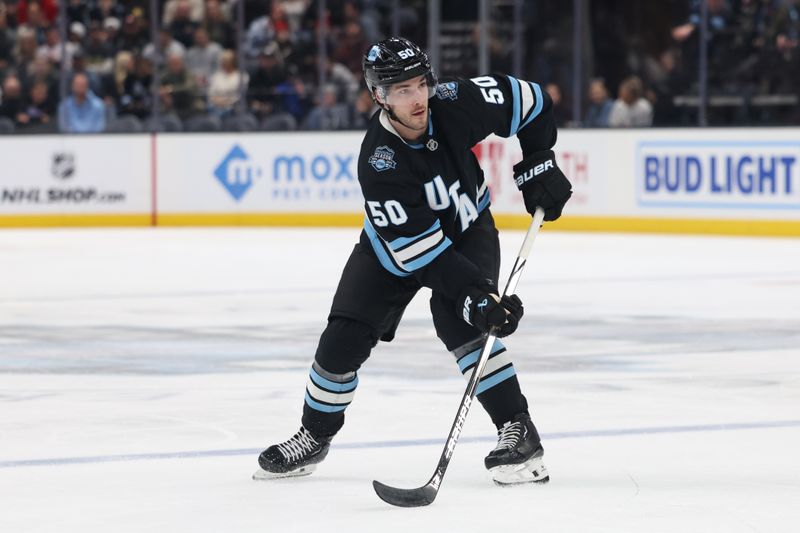 Feb 25, 2025; Salt Lake City, Utah, USA; Utah Hockey Club defenseman Sean Durzi (50) looks for a play against the Chicago Blackhawks during the second period at Delta Center. Mandatory Credit: Rob Gray-Imagn Images