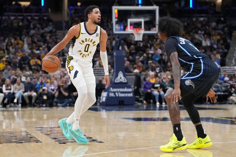 INDIANAPOLIS, INDIANA - NOVEMBER 06: Tyrese Haliburton #0 of the Indiana Pacers dribbles the ball while being guarded by Kentavious Caldwell-Pope #3 of the Orlando Magic in the third quarter at Gainbridge Fieldhouse on November 06, 2024 in Indianapolis, Indiana. NOTE TO USER: User expressly acknowledges and agrees that, by downloading and or using this photograph, User is consenting to the terms and conditions of the Getty Images License Agreement. (Photo by Dylan Buell/Getty Images)