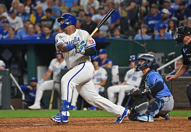 Jul 3, 2024; Kansas City, Missouri, USA;  Kansas City Royals catcher Salvador Perez (13) drives in two runs with a single in the seventh inning against the Tampa Bay Rays at Kauffman Stadium. Mandatory Credit: Peter Aiken-USA TODAY Sports