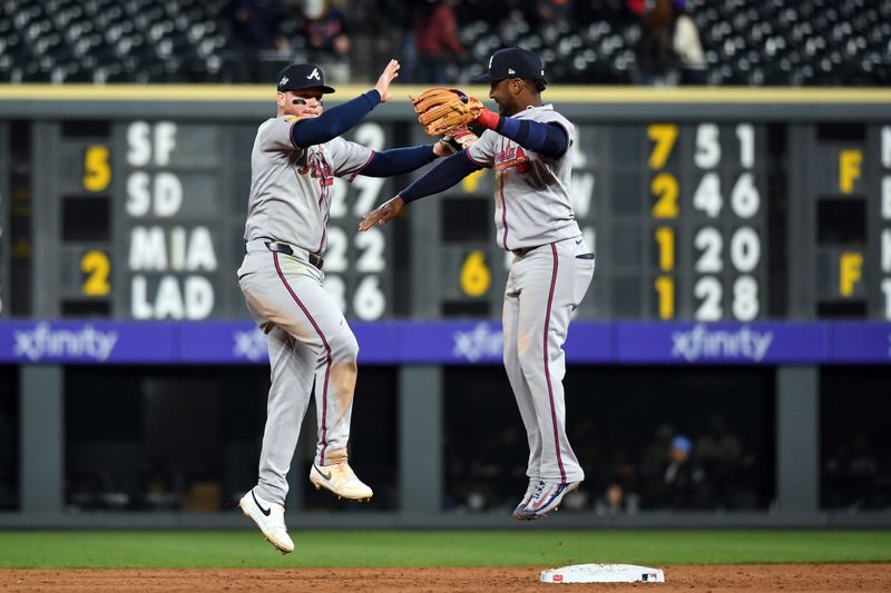Apr 29, 2025; Denver, Colorado, USA; Atlanta Braves outfielder Alex Verdugo (8) and second base Ozzie Albies (1) celebrate after a win against the Colorado Rockies at Coors Field. Mandatory Credit: Christopher Hanewinckel-Imagn Images
