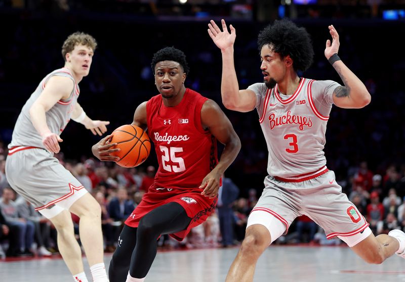 Feb 17, 2026; Columbus, Ohio, USA; Wisconsin Badgers guard John Blackwell (25) protects the ball as Ohio State Buckeyes guard Taison Chatman (3) defends during the first half at Value City Arena. Mandatory Credit: Joseph Maiorana-Imagn Images