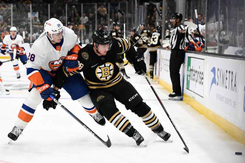 Nov 9, 2023; Boston, Massachusetts, USA; Boston Bruins center Patrick Brown (38) skates against New York Islanders defenseman Alexander Romanov (28) during the first period at the TD Garden. Mandatory Credit: Brian Fluharty-USA TODAY Sports