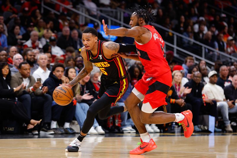 ATLANTA, GEORGIA - FEBRUARY 23: Dejounte Murray #5 of the Atlanta Hawks drives against Immanuel Quickley #5 of the Toronto Raptors during the second quarter at State Farm Arena on February 23, 2024 in Atlanta, Georgia. NOTE TO USER: User expressly acknowledges and agrees that, by downloading and or using this photograph, User is consenting to the terms and conditions of the Getty Images License Agreement. (Photo by Todd Kirkland/Getty Images)