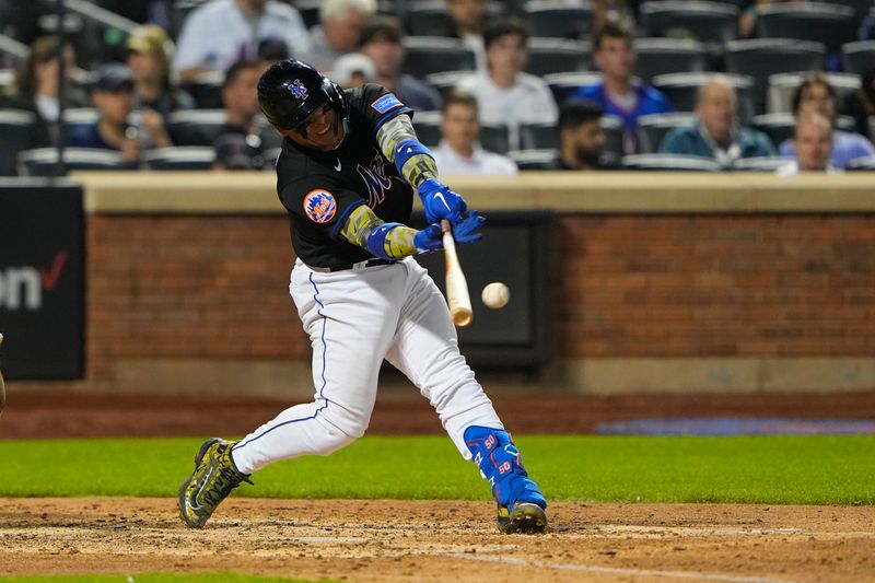 May 21, 2023; New York City, New York, USA; New York Mets catcher Francisco Alvarez (4) hits a single against the Cleveland Guardians during the eighth inning at Citi Field. Mandatory Credit: Gregory Fisher-USA TODAY Sports