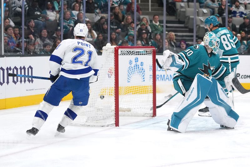 Jan 3, 2026; San Jose, California, USA; Tampa Bay Lightning center Brayden Point (21) scores against San Jose Sharks goaltender Yaroslav Askarov (right) during the first period at SAP Center at San Jose. Mandatory Credit: Darren Yamashita-Imagn Images