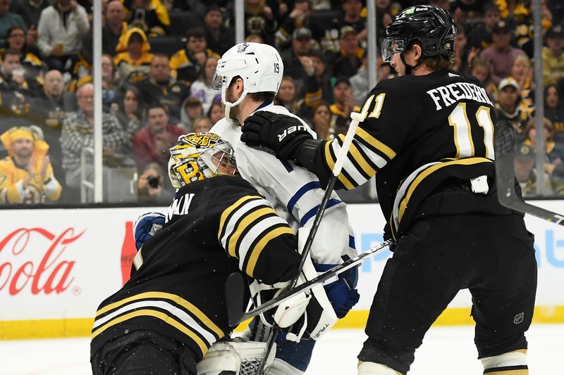 May 4, 2024; Boston, Massachusetts, USA; Toronto Maple Leafs center Calle Jarnkrok (19) skates into Boston Bruins goaltender Jeremy Swayman (1) during the second period in game seven of the first round of the 2024 Stanley Cup Playoffs at TD Garden. Mandatory Credit: Bob DeChiara-USA TODAY Sports