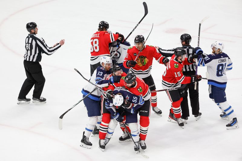 Feb 23, 2024; Chicago, Illinois, USA; Chicago Blackhawks and Winnipeg Jets players fight with each other during the second period at United Center. Mandatory Credit: Kamil Krzaczynski-USA TODAY Sports