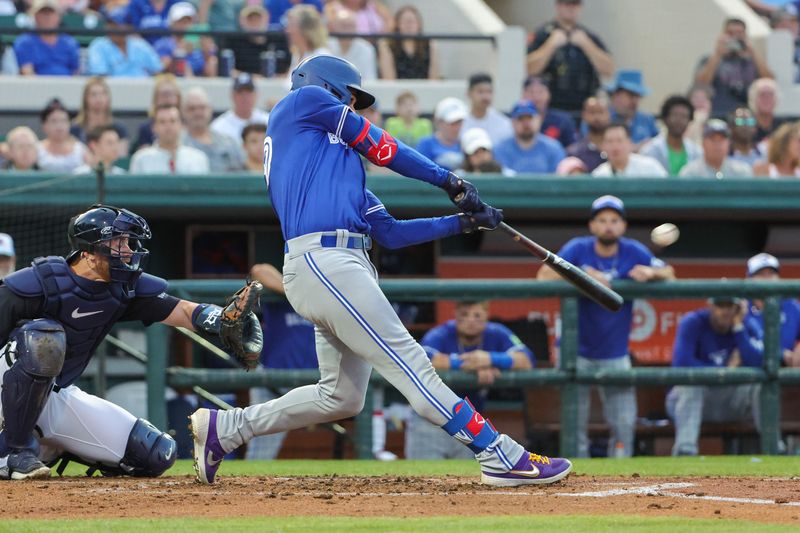 Mar 7, 2024; Lakeland, Florida, USA; Toronto Blue Jays left fielder Daulton Varsho (25) bats during the second inning against the Detroit Tigers at Publix Field at Joker Marchant Stadium. Mandatory Credit: Mike Watters-USA TODAY Sports