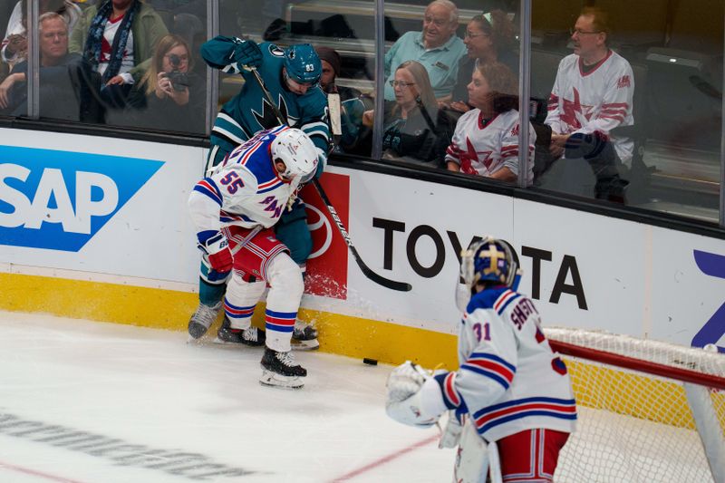 Nov 19, 2022; San Jose, California, USA; San Jose Sharks left wing Matt Nieto (83) and New York Rangers defenseman Ryan Lindgren (55) battle for the puck behind the net during the third period at SAP Center at San Jose. Mandatory Credit: Neville E. Guard-USA TODAY Sports