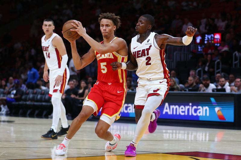 MIAMI, FLORIDA - OCTOBER 16: Dyson Daniels #5 of the Atlanta Hawks drives against Terry Rozier #2 of the Miami Heat during the second quarter of a preseason game at Kaseya Center on October 16, 2024 in Miami, Florida. NOTE TO USER: User expressly acknowledges and agrees that, by downloading and or using this photograph, User is consenting to the terms and conditions of the Getty Images License Agreement. (Photo by Megan Briggs/Getty Images)