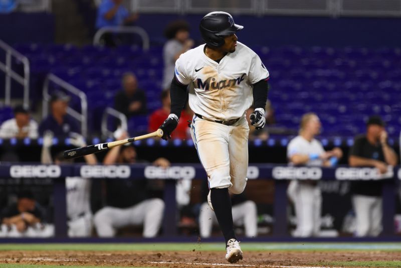 Sep 4, 2024; Miami, Florida, USA; Miami Marlins shortstop Xavier Edwards (63) hits a walk-off single against the Washington Nationals during the tenth inning at loanDepot Park. Mandatory Credit: Sam Navarro-Imagn Images