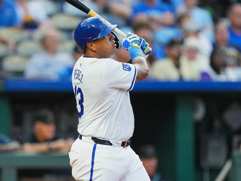 Jul 22, 2024; Kansas City, Missouri, USA; Kansas City Royals catcher Salvador Perez (13) hits a home run during the third inning against the Arizona Diamondbacks at Kauffman Stadium. Mandatory Credit: Jay Biggerstaff-USA TODAY Sports