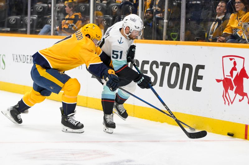 Mar 6, 2025; Nashville, Tennessee, USA;  dNashville Predators defenseman Marc Del Gaizo (7) and Seattle Kraken center Shane Wright (51) battle for the puck uring the second period at Bridgestone Arena. Mandatory Credit: Steve Roberts-Imagn Images