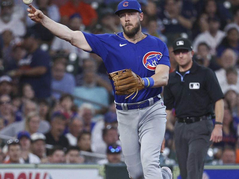 May 17, 2023; Houston, Texas, USA; Chicago Cubs third baseman Patrick Wisdom (16) throws out a runner at first base during the first inning against the Houston Astros at Minute Maid Park. Mandatory Credit: Troy Taormina-USA TODAY Sports