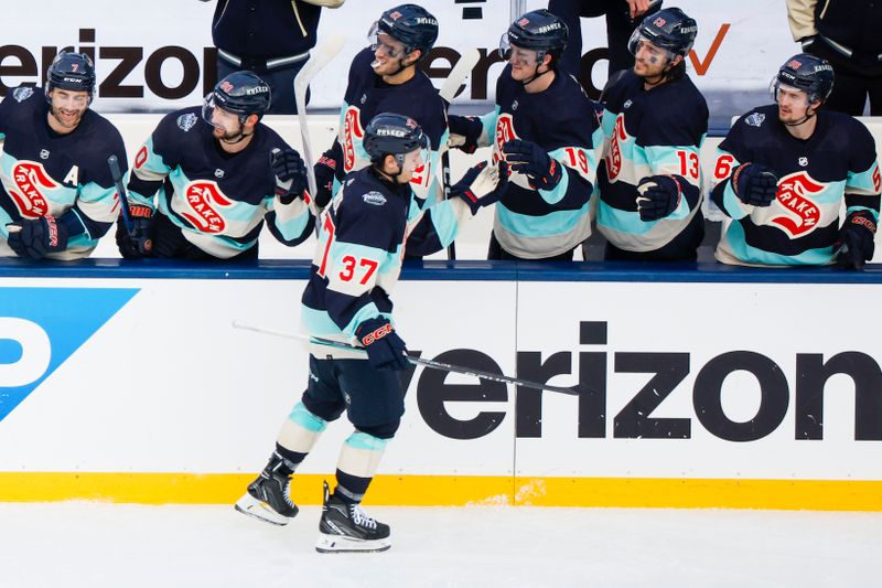 Jan 1, 2024; Seattle, Washington, USA; Seattle Kraken center Yanni Gourde (37) celebrates with teammates on the bench after scoring a goal against the Vegas Golden Knights during the third period in the 2024 Winter Classic ice hockey game at T-Mobile Park. Mandatory Credit: Joe Nicholson-USA TODAY Sports