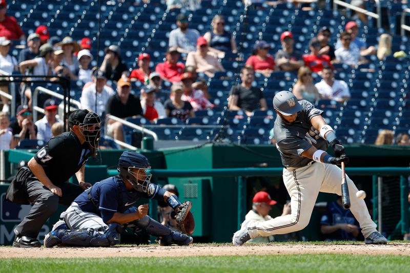 Apr 5, 2023; Washington, District of Columbia, USA; Washington Nationals catcher Keibert Ruiz (20) singles against the Tampa Bay Rays during the third inning at Nationals Park. Mandatory Credit: Geoff Burke-USA TODAY Sports